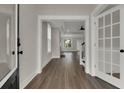 Inviting entryway with wood floors and glass paned door leading into the living area at 2020 Grange Cir, Summerville, SC 29486