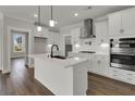 Modern kitchen with stainless steel appliances, white cabinets, and a large island at 2020 Grange Cir, Summerville, SC 29486