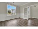 Living room featuring a large window, wood floors, and a paneled accent wall at 2020 Grange Cir, Summerville, SC 29486