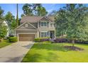 Charming two-story home features a two-car garage, well-kept lawn, and thoughtfully designed landscaping at 206 President Cir, Summerville, SC 29483