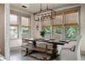Elegant dining room with natural light, a rustic table, and seating for eight at 2234 Kemmerlin St, Johns Island, SC 29455
