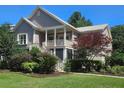 Charming two-story home with well-manicured lawn and lush landscaping, including a covered porch with stairs at 2517 Charter Oaks Dr, Mount Pleasant, SC 29466
