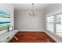 Bright living room with gleaming hardwood floors, chandelier, and a large window offering ample natural light at 2517 Charter Oaks Dr, Mount Pleasant, SC 29466