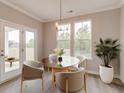 Bright dining area with a glass-top table, modern chairs, and a view of the outdoor space at 2703 Grange Cir, Summerville, SC 29486