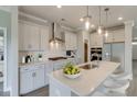 Modern kitchen featuring stainless steel appliances, white cabinets, and a spacious center island at 2703 Grange Cir, Summerville, SC 29486