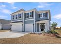 Two-story home with a three-car garage and a well-maintained front yard at 2807 Grange Cir, Summerville, SC 29486