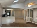 Inviting living room with vaulted ceilings, skylight and a seamless transition to the tiled kitchen area at 2827 Haverhill Cir, North Charleston, SC 29420