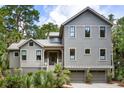 Attractive two-story home with gray siding, black-trim windows, and a two-car garage at 3125 Privateer Creek Rd, Seabrook Island, SC 29455