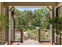 Inviting front porch offering scenic views of the surrounding greenery and landscaped yard at 3125 Privateer Creek Rd, Seabrook Island, SC 29455