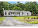 Charming single story home with grey siding, black shutters and well maintained front lawn at 3284 Sassy Dr, Johns Island, SC 29455