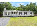 Charming single story home with grey siding, black shutters and well maintained front lawn at 3284 Sassy Dr, Johns Island, SC 29455