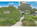 Welcoming entrance to the Dockside community with lush greenery and secure gate at 330 Concord St # 12C, Charleston, SC 29401
