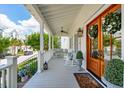 Inviting front porch with rocking chairs, a porch swing, and double doors adorned with wreaths at 371 Bridgetown Pass, Mount Pleasant, SC 29464
