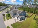 Aerial view of home and neighborhood showcasing lush landscaping and well-maintained surroundings at 443 Coopers Hawk Dr, Summerville, SC 29483