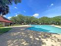A lovely community pool is shown with a clear blue sky backdrop, and various trees lining the perimeter at 4630 Palm View Cir, North Charleston, SC 29418