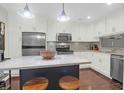 Modern kitchen featuring stainless steel appliances, an island with seating, and white cabinets at 4752 Trailside Ct # B, North Charleston, SC 29418