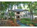 Beautiful multi-story home surrounded by lush greenery, offering a tranquil setting with a unique architectural design at 4856 Green Dolphin Way # Share 5, Kiawah Island, SC 29455