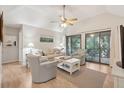 Cozy living room with vaulted ceilings, neutral-toned furniture, sliding doors to a balcony and serene decor at 4856 Green Dolphin Way # Share 5, Kiawah Island, SC 29455