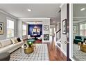 This elegant living room boasts hardwood floors, modern furnishings, and ample natural light from large windows at 528 Fern Tree Dr, Summerville, SC 29486