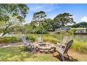 Inviting backyard firepit surrounded by seating, creating a cozy outdoor gathering space at 634 Lynne Ave, Charleston, SC 29412