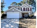 Charming two-story home with gray siding, red shutters, two car garage, and a well-maintained front lawn at 7277 Sweetgrass Blvd, Hanahan, SC 29410