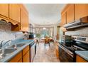 Cozy eat-in kitchen featuring classic cabinets, stainless steel appliances, and ample natural light at 8204 Pleasant Ridge Dr, Charleston, SC 29420