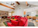 Open-concept living room with exposed beams, brick fireplace, and comfortable seating area at 8204 Pleasant Ridge Dr, Charleston, SC 29420