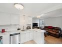 Modern kitchen with stainless steel dishwasher and view into cozy living room area at 9 F St, Charleston, SC 29403