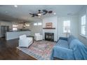 Inviting living area featuring a cozy fireplace, plush seating, and an open layout perfect for entertaining and relaxation at 977 Warrick Oaks Ln, Mount Pleasant, SC 29464