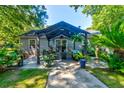 Backyard patio with shaded pergola with outdoor seating and lush landscaping at 102 Cottonwood Dr, Summerville, SC 29483