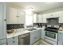 Stylish kitchen featuring stainless steel appliances, granite countertops, and two-tone cabinetry at 104 Queens Ct, Summerville, SC 29485