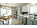 Inviting kitchen with gray and white cabinets, stainless steel appliances, and dining area at 104 Queens Ct, Summerville, SC 29485
