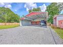 Spacious carport structure ideal for boat storage, with durable gravel flooring at 108 Reardon St, Moncks Corner, SC 29461