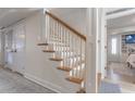 Traditional wood and white staircase with view into living area at 109 Carolina Blvd, Isle of Palms, SC 29451
