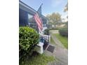 View of the entrance to the screened porch and manicured yard at 1124 Davidson Ave, Charleston, SC 29407