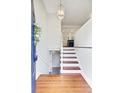 Bright foyer featuring hardwood floors, modern lighting, white walls, and a glimpse into the open kitchen at 1525 Westmoreland Ave, Charleston, SC 29412