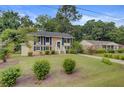 Well-maintained two-story home with a classic brick facade, manicured lawn, and mature trees at 1525 Westmoreland Ave, Charleston, SC 29412