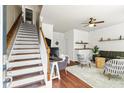 Bright entryway features hardwood floors, stairs with a carpet runner, and adjacent living space at 1543 Bluewater Way, Charleston, SC 29414