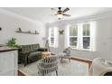 Bright living room with hardwood floors, a ceiling fan, and plenty of natural light from large windows at 1543 Bluewater Way, Charleston, SC 29414