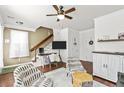 Cozy living room featuring hardwood floors, a ceiling fan, and stairs leading to the second floor at 1543 Bluewater Way, Charleston, SC 29414