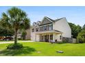 Well-maintained home with a spacious front yard and a covered front porch at 158 Balsam Cir, Summerville, SC 29485