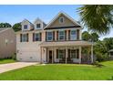 Charming two-story home with a welcoming front porch and manicured lawn at 158 Balsam Cir, Summerville, SC 29485