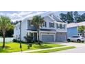 Attractive home boasts lush green lawn, palm trees, attached garage, and inviting curb appeal at 1630 Mermentau St, Mount Pleasant, SC 29466