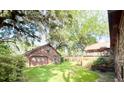 Backyard view of brick detached garage with beautiful green grass at 1807 Perch Rd, Moncks Corner, SC 29461