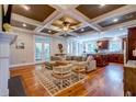 Spacious living room featuring an open concept, coffered ceilings, hardwood floors, and modern finishes at 1872 Staffwood Rd, Johns Island, SC 29455