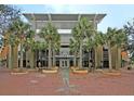 Modern building exterior featuring palm trees, brick paving, and architectural design at 225 Seven Farms Dr # 307, Daniel Island, SC 29492
