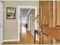 Inviting entryway featuring a hardwood floor, art, and a charming glimpse into the interior at 225 Seven Farms Dr # 307, Daniel Island, SC 29492
