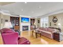 Bright living room with hardwood floors, a fireplace, built-in cabinets, and stylish furnishings at 225 Seven Farms Dr # 307, Daniel Island, SC 29492
