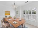 Elegant dining room with a modern chandelier and shuttered windows at 241 Howle Ave # G, Charleston, SC 29412