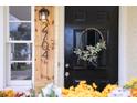 Stylish front door featuring modern house numbers, wreath, and a welcoming entryway at 2704 Orchid Ave, North Charleston, SC 29405